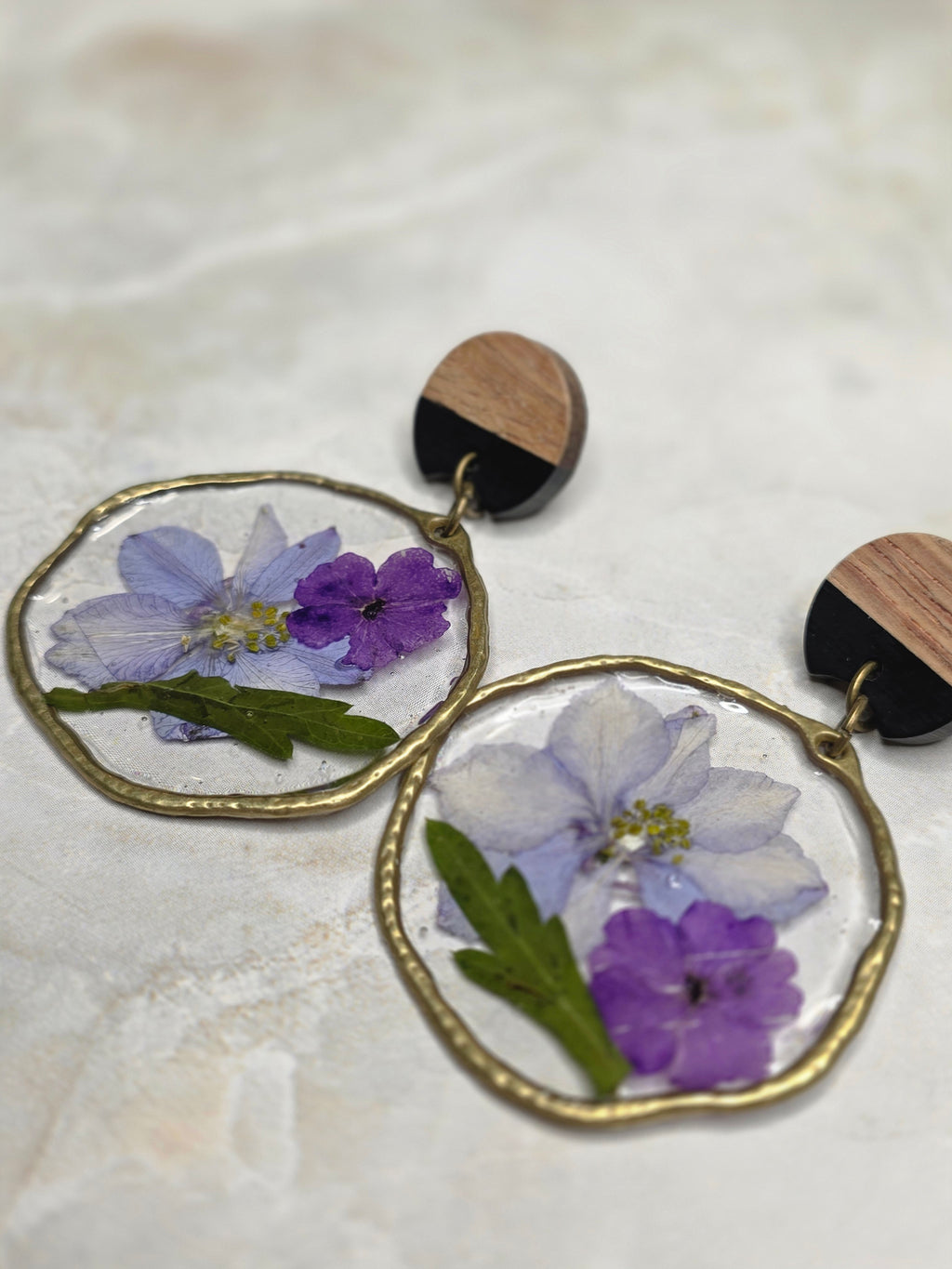 Earrings with floral designs on a light background